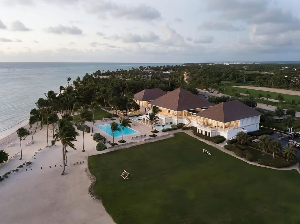 Arrive to a beachfront estate with poolside sunset glow.