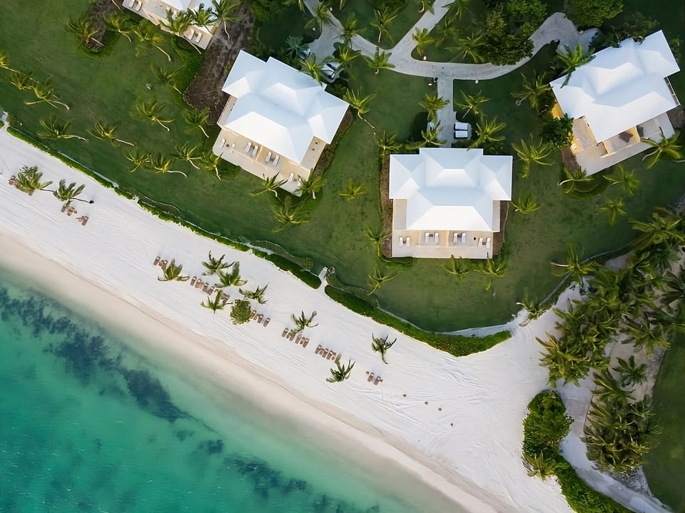 Picture your villa steps from loungers and gentle surf.