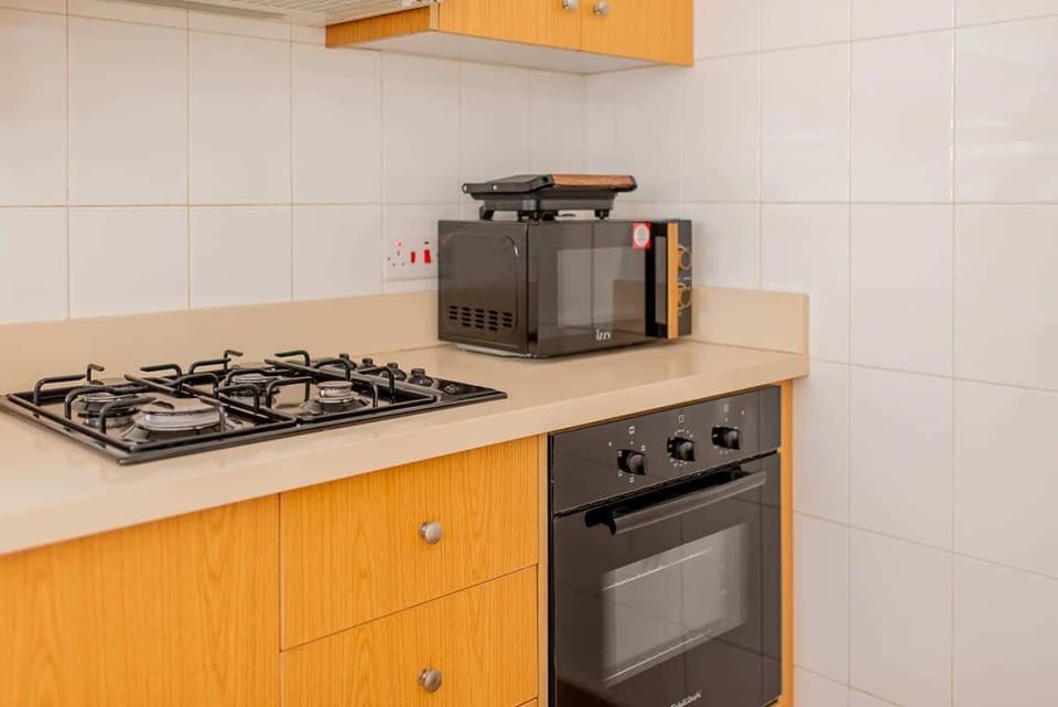 Microwave, sandwich maker, and oven; fully equipped for a comfortable stay. 