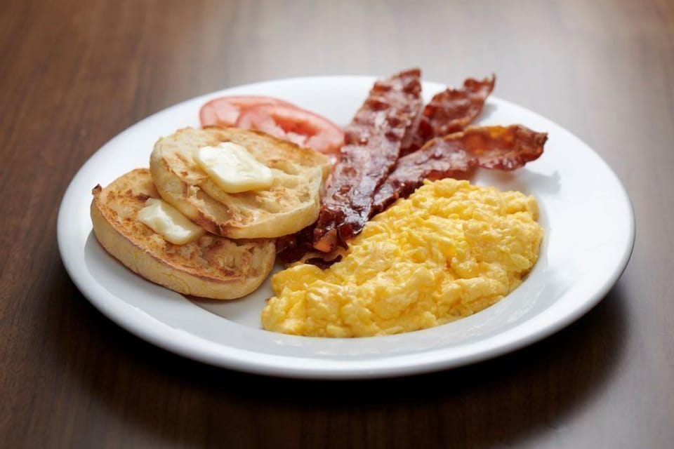 Daily complimentary breakfast! Plated hot breakfast with eggs, bacon, and toast.