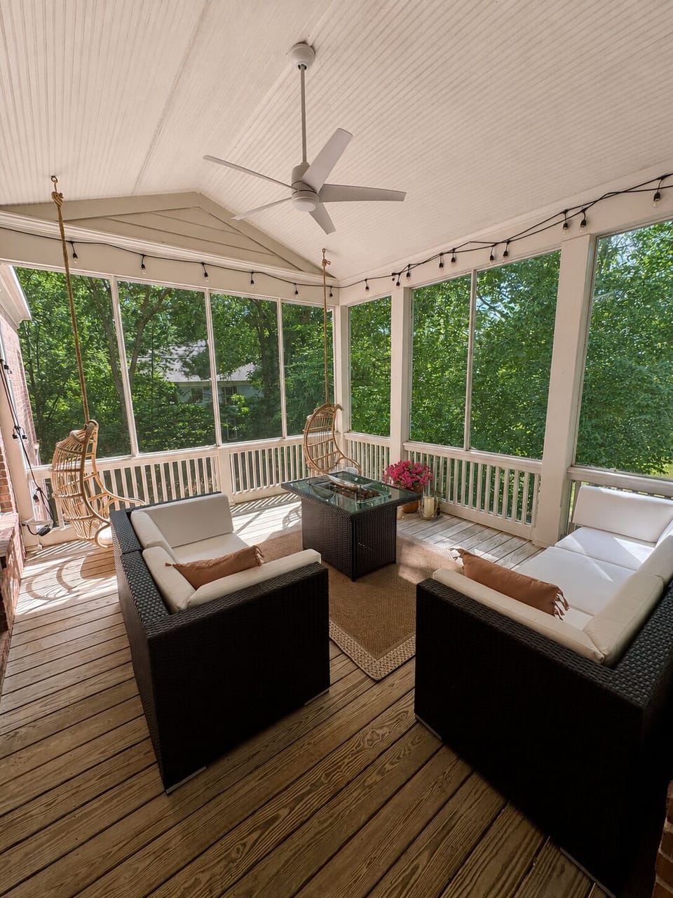 Upstairs screened in porch with fire pit table.