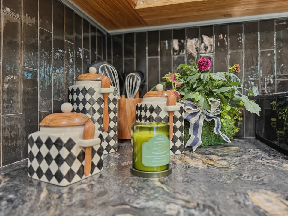 Every detail delights in this stylish kitchen, featuring luxe stone counters and elegant decorative touches — where mountain charm meets refined design.