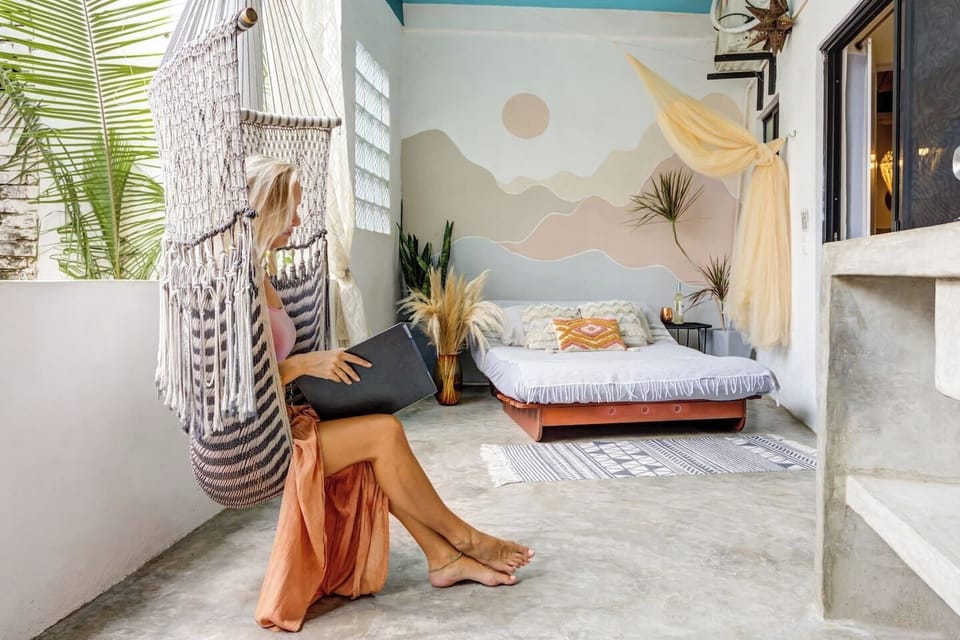 Private outdoor oasis with daybed, hammock swing, and outdoor kitchen.
