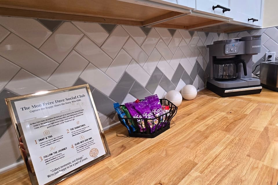 Inviting coffee station with snacks and stylish modern backsplash