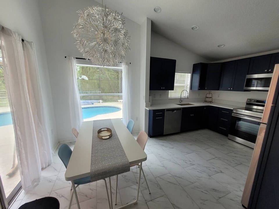 Step from the living room right into our BRAND NEW open floor plan Kitchen with clear views of the pool and a sliding door to the lanai and pool deck!