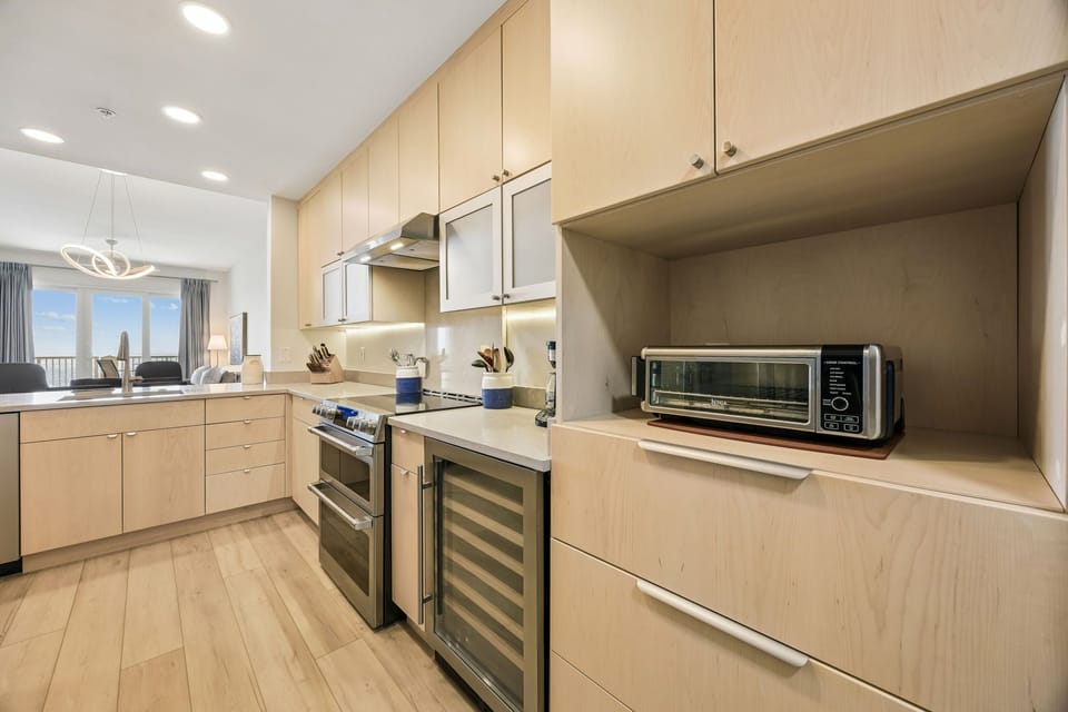 Spacious Modern Kitchen with Stainless Steel Appliances, Induction Stove, Wine Cooler, and Large Walk In Pantry