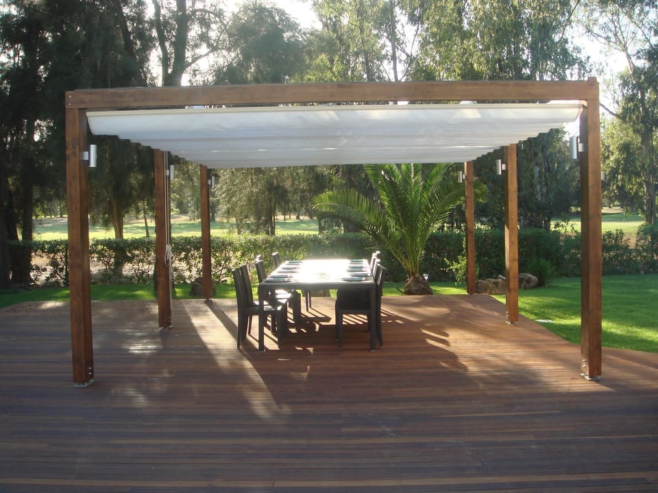 Pergola - Golf View  |  There’s nothing better than sharing outdoor meals with family and friends on this deck, with views of the golf course, garden, and pool. Shady and cool in summer, with the option to open the canopy to enjoy the winter sun.
      