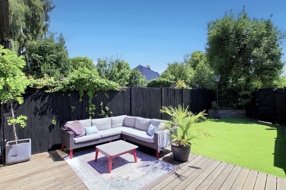 Garden Retreat: Lush lawn and stylish deck seating - your private spot for outdoor relaxation!