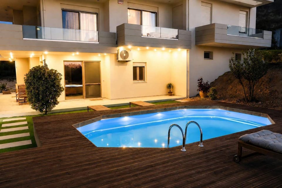 Evening view of the villa’s private pool and outdoor deck.