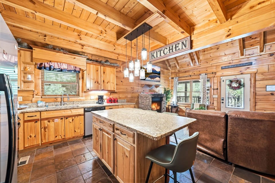 Fully equipped kitchen with granite countertops, stainless steel appliances, and seating for 4.
