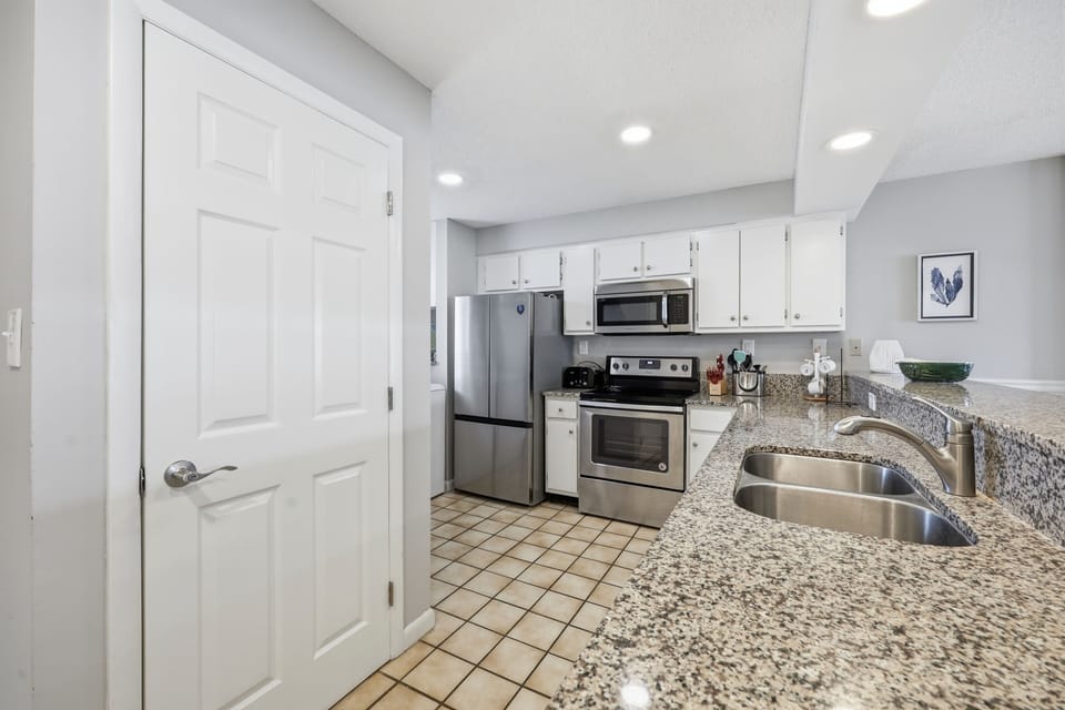 Your fully equipped kitchen features granite counters, stainless steel appliances, and everything you need to whip up delicious vacation meals together.