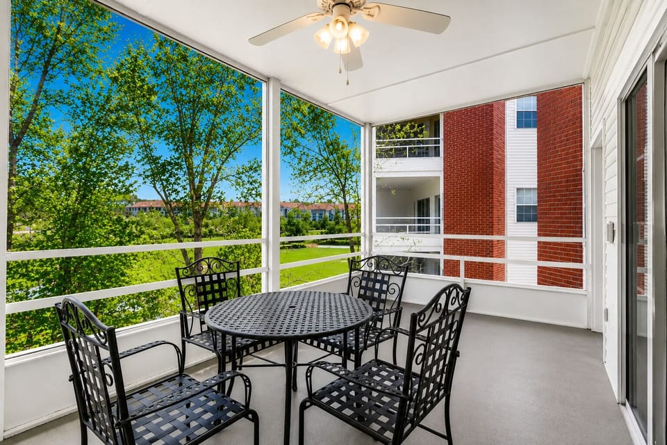 The screened patio offers a view of the resort pool and the golf course.