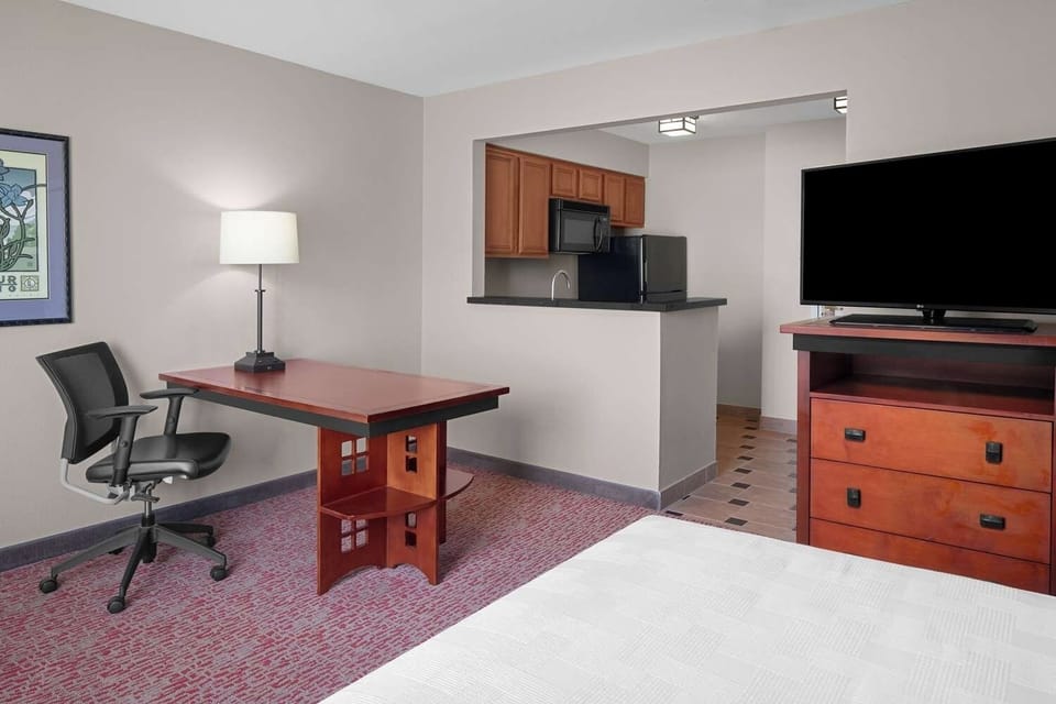 Stretch out and enjoy extra space with TV and desk.
