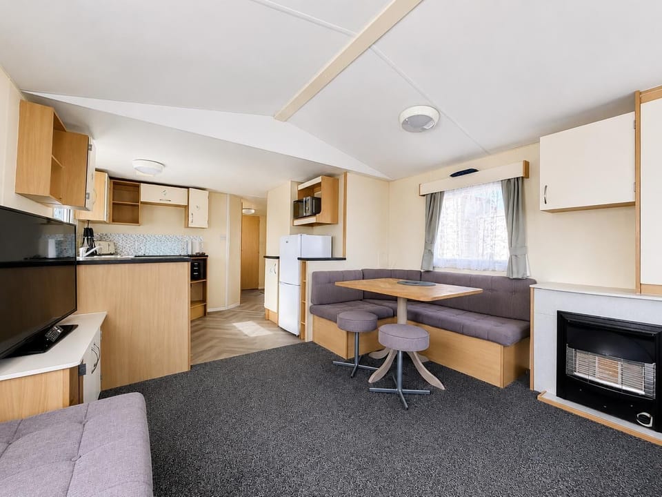 The kitchen area in a caravan at Parkdean Resorts Naze Marine Holiday Park Essex is perfect for preparing family meals during your UK staycation near Ipswich Town.