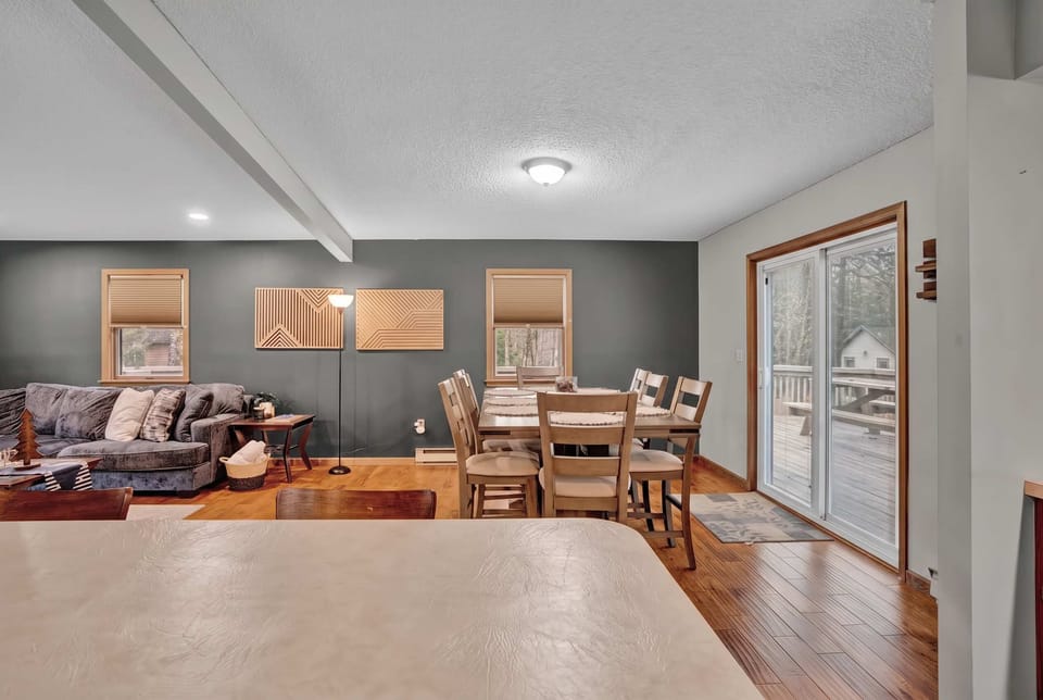 
Open common area keeps everyone connected — living, dining, and a slider to the outdoors all in one comfortable space.