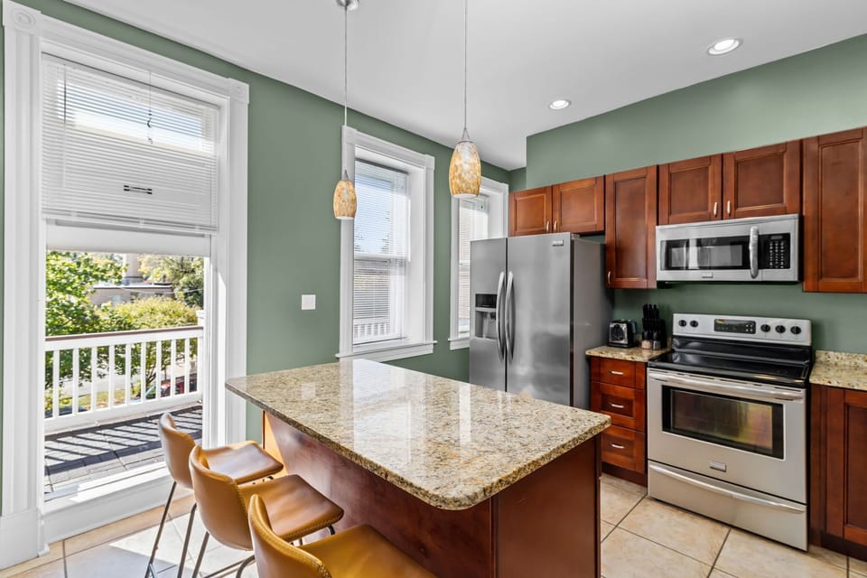 Cook with a view — natural light pours in while you prep at the granite island, with the balcony just steps away when it's time to take the party outside.