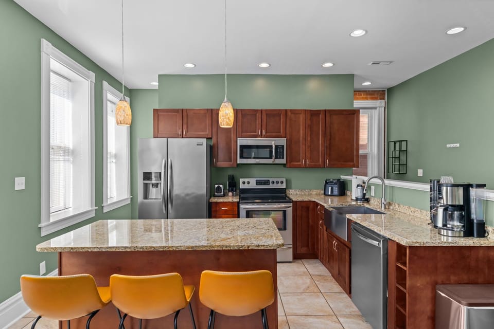A kitchen that actually keeps up with your group — full stainless appliances, granite counters, and a breakfast bar with seating make cooking in just as easy as eating out.