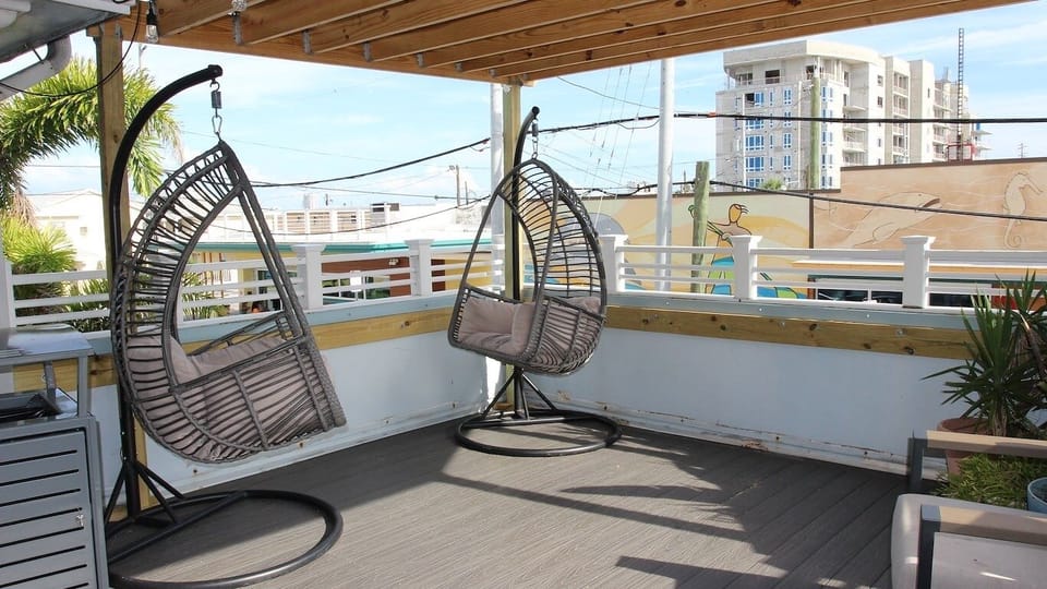 Unwind in hanging chairs with breezy, sunlit coastal views.