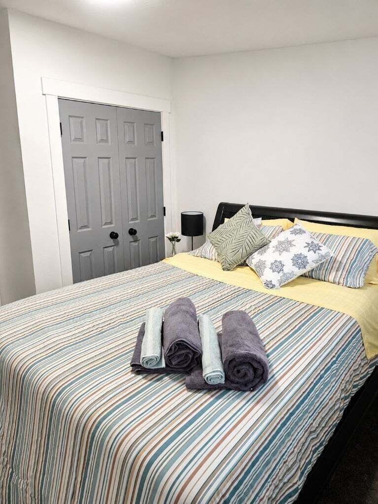 Comfortable queen bedroom with soft bedding.