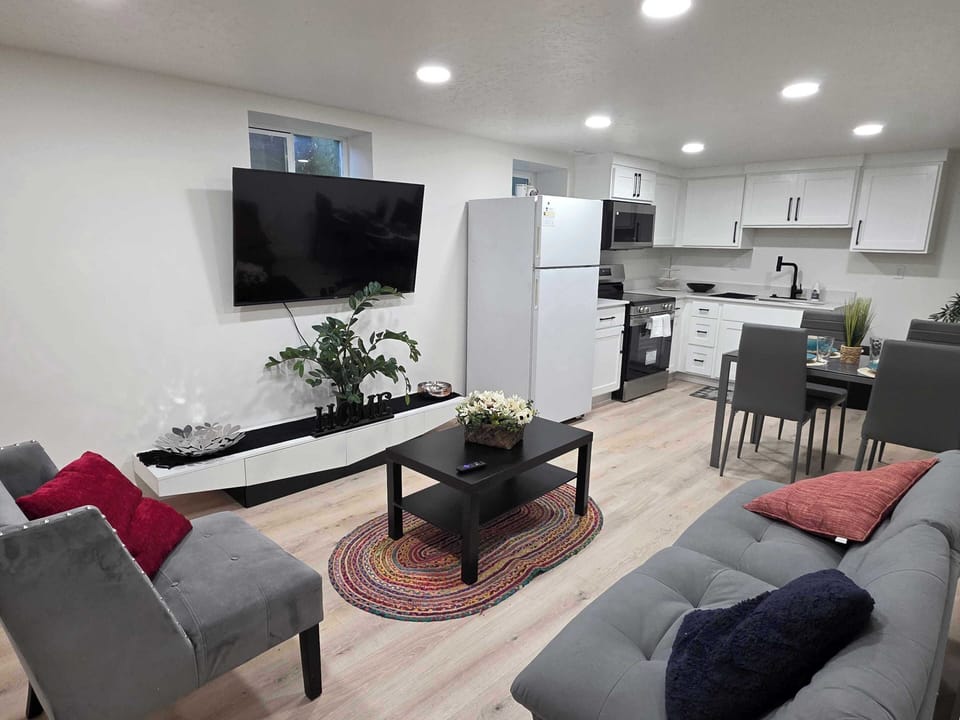 Living room with flat-screen TV and cozy seating.