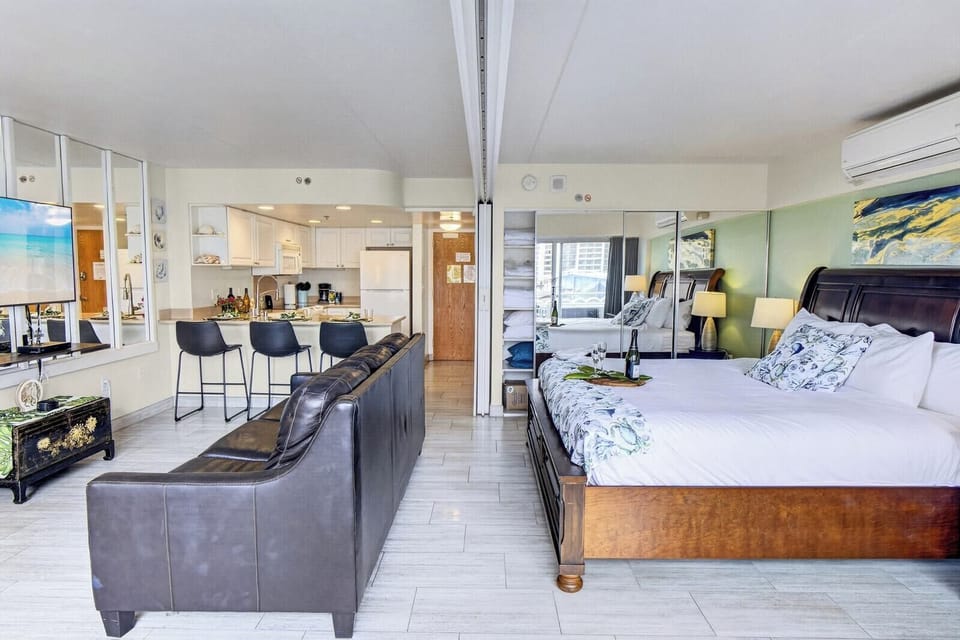 Bedroom area featuring a plush king-size bed and large windows for a bright feel.
