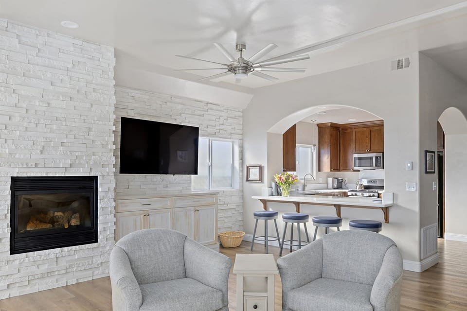 Living room with TV and fireplace