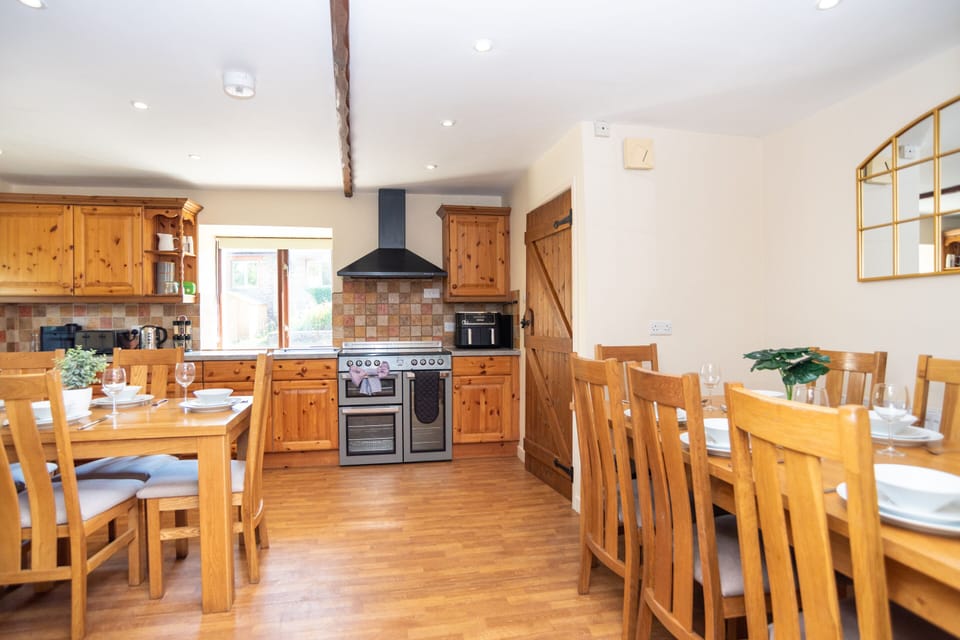Traditional country-style kitchen and dining area, fully equipped for self-catering holidays and group meals during your North Devon stay.