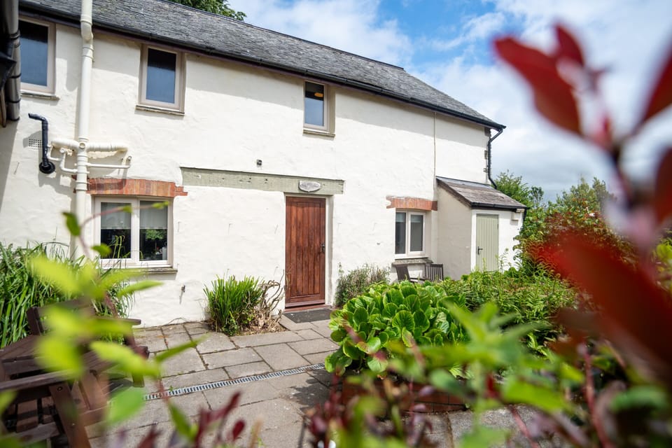Characterful stone buildings, colourful gardens and peaceful countryside make Old Mill Cottages a beautiful base for exploring North Devon.