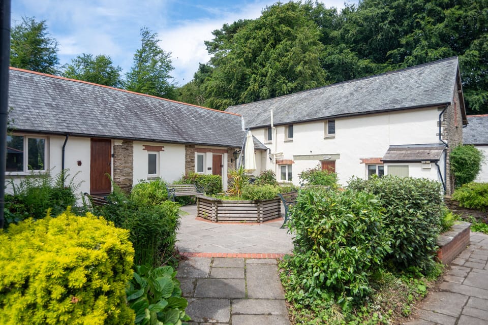 Step outside into the peaceful courtyard at Old Mill Cottages, surrounded by characterful stone buildings, gardens and countryside.