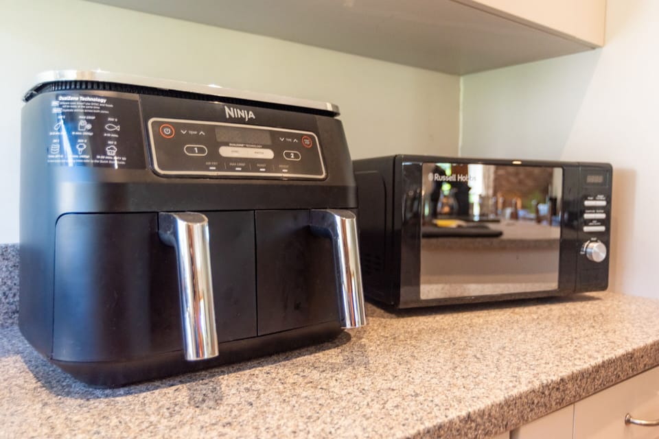 Cook with ease in The Barn's well-equipped kitchen, with an air fryer and microwave alongside everything you need for relaxed self-catering stays.