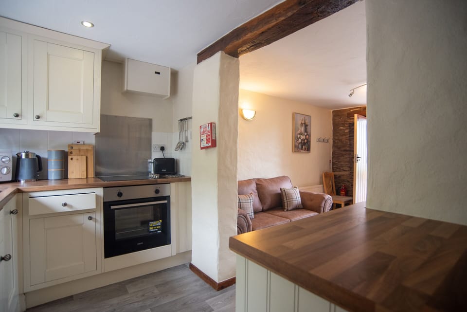 The open-plan layout combines the kitchen and lounge areas, creating a welcoming space to relax and enjoy your North Devon escape.