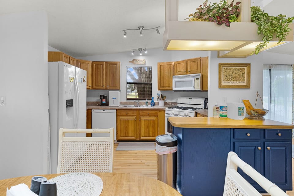 Gather around the kitchen island to prep meals in a bright, welcoming space with natural light and abundant counter space. The full kitchen makes it easy to cook your favorite dishes just like home.