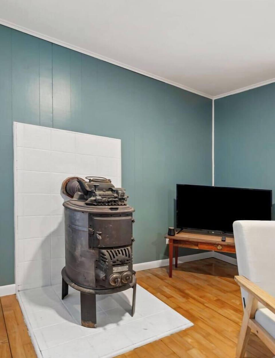 Charming vintage wood burning stove adds rustic mountain character to this Mars Hill retreat. A cozy focal point that enhances the warm cabin style ambiance, perfect for relaxing evenings in the Blue Ridge Mountains.