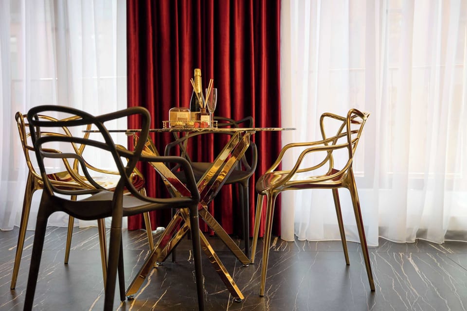 Apartament łączy luksusowy styl glamour, elementy art déco, głębokie kolory, złote detale, lustrzane powierzchnie oraz spektakularne oświetlenie. Każda część wnętrza została dopracowana tak, aby tworzyć spójną, elegancką i nastrojową przestrzeń.
