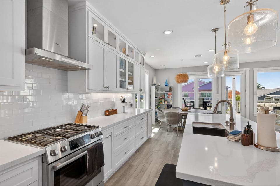 Elegant kitchen with stainless appliances and white cabinets.