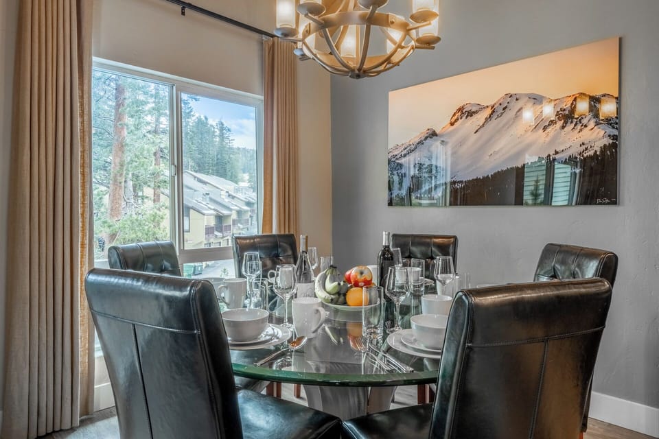 Gather around this elegant dining table for memorable meals with your group. The mountain-view window and stunning alpine artwork set the perfect scene for your stay.