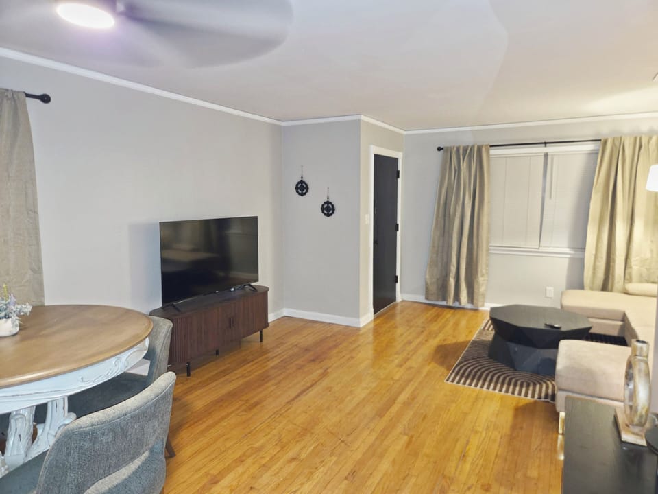 Bright open living and dining space with modern style and warm wood floors