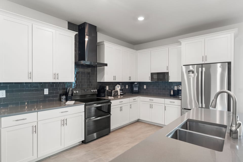 Modern chef’s kitchen with island, double sink, and stainless appliances