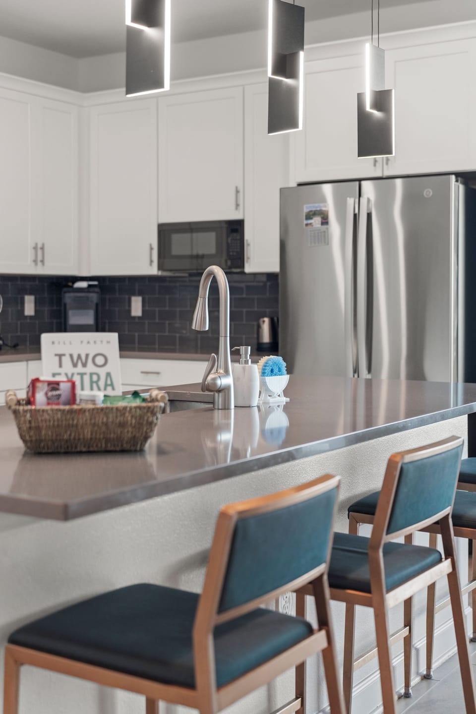 Bright modern kitchen with island seating and sleek stainless appliances