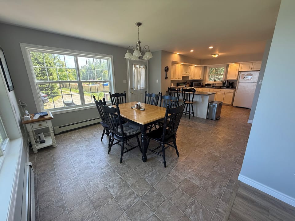 Long angle of dining and kitchen areas 