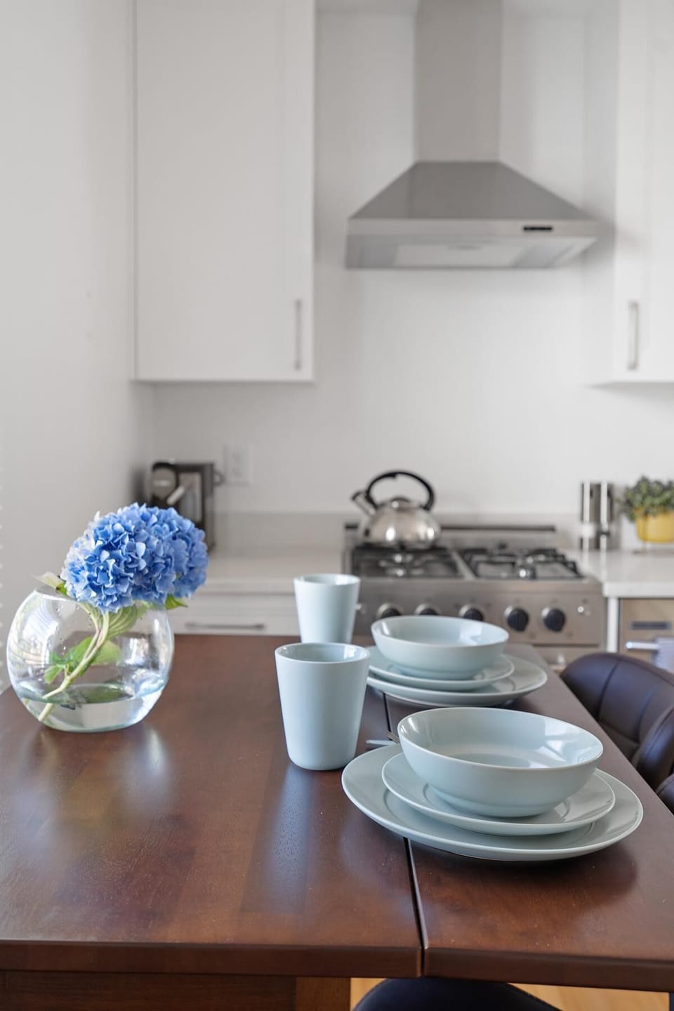 Alternate perspective of the dining table setup positioned near the cooking area.