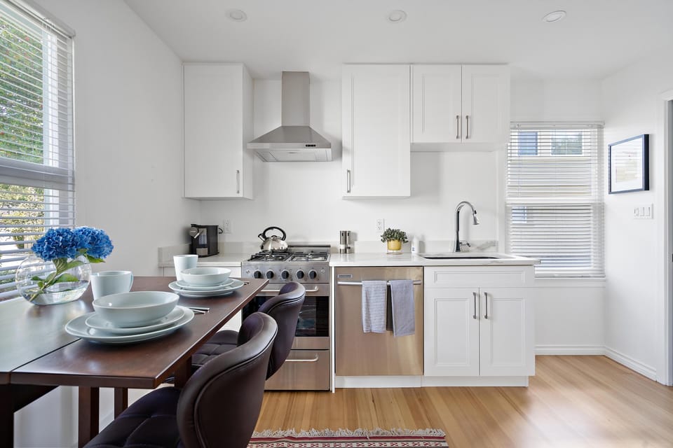 Modern gourmet kitchen equipped with a full gas range, built-in dishwasher, and ample counter space.