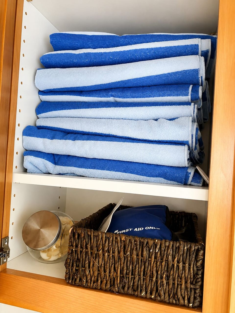 Well-stocked linen cabinet with fresh towels and thoughtful guest essentials