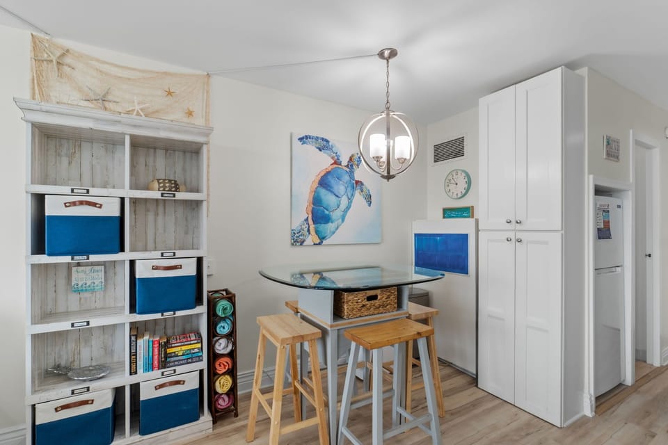 Dining table with seating for 4 plus storage shelves.