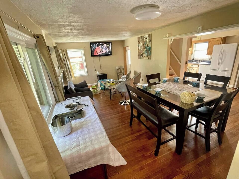 Open concept kitchen-dinning-living area. View from the dining room. Optional setup with serving table. 