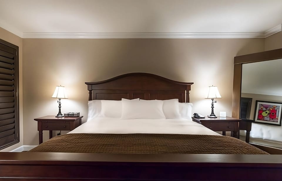Unwind into crisp linens under warm bedside lighting.
