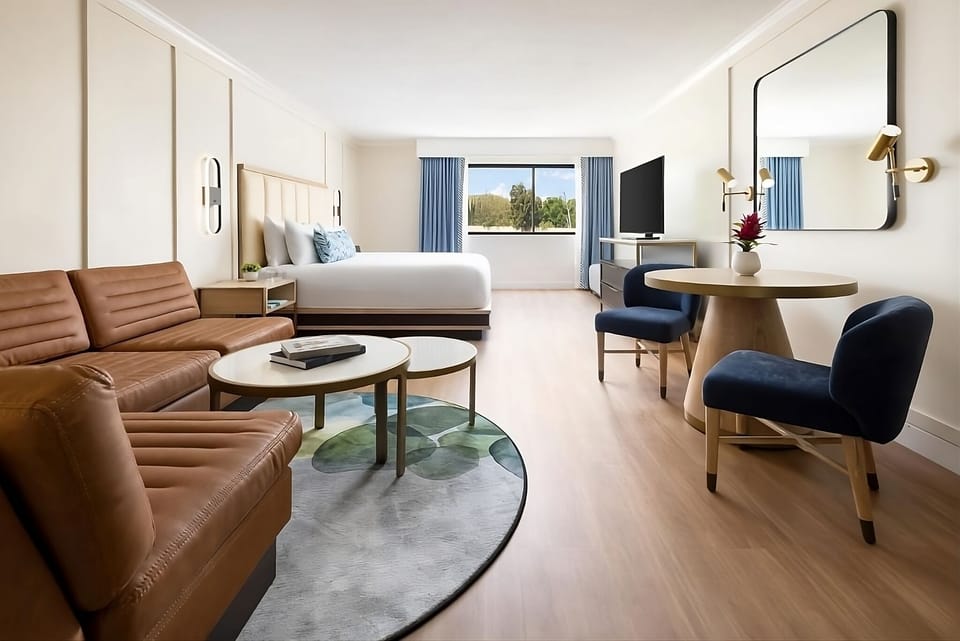 Unwind in a bright suite with sofa, king bed, views.