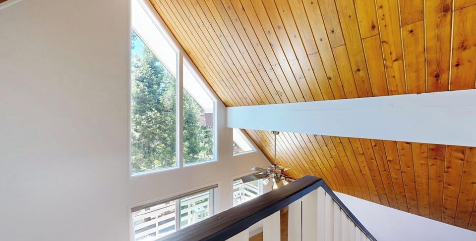 Stairs with beautiful views heading up to the top level of the home.