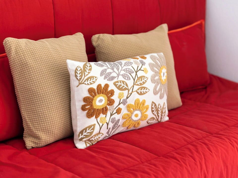 Cushion, Interior Design, Red, Furniture, Yellow, Linens, Throw Pillow, Textile, Pillow, Orange