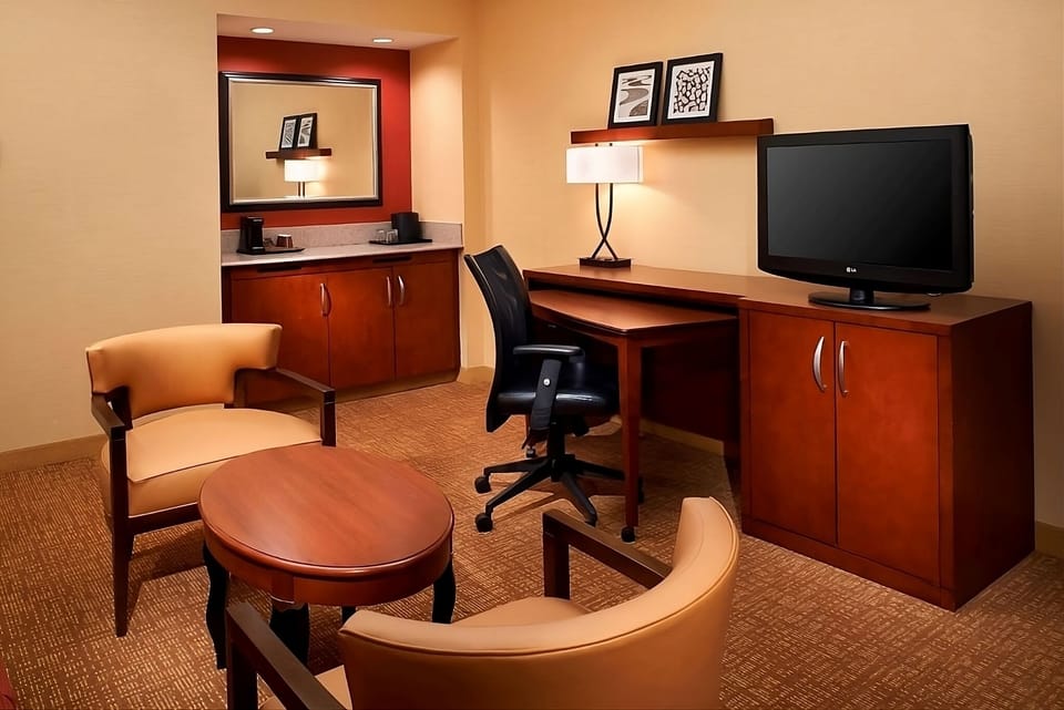 Recharge with a cozy seating area and spacious work desk.